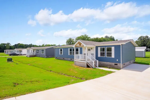 a front view of house with yard and green space