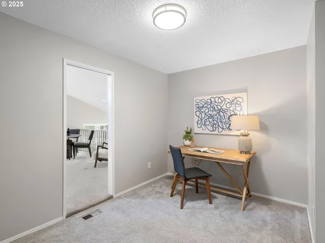 a living room with furniture and a lamp
