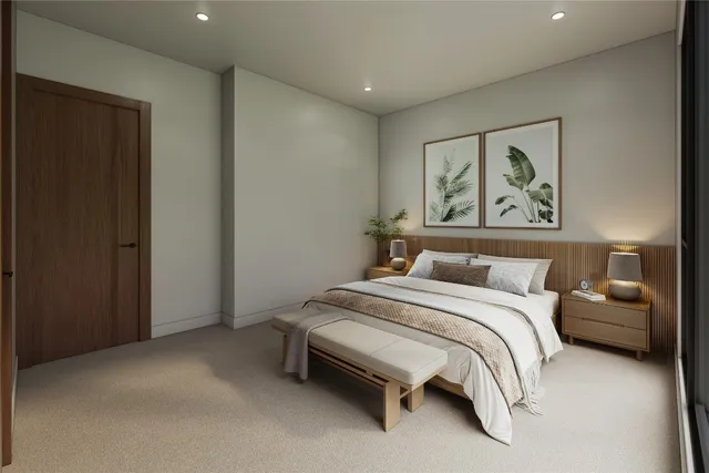 a bedroom with a bed and a painting on the wall