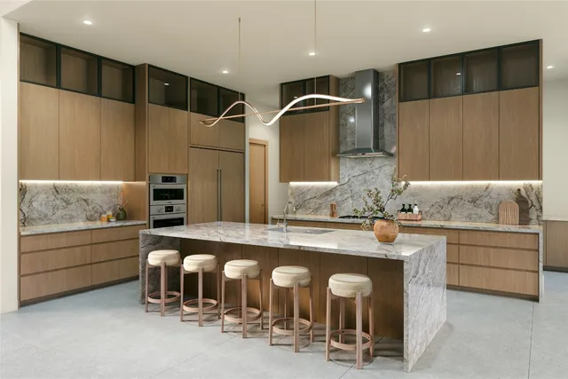 a kitchen with stainless steel appliances kitchen island granite countertop a refrigerator and stove