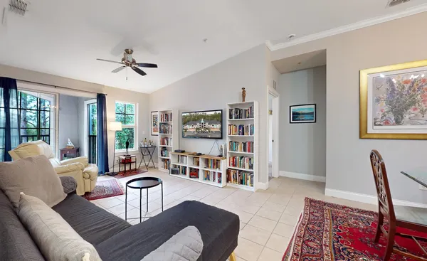 a living room with furniture a rug and a window
