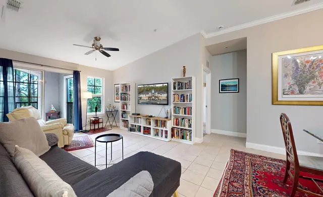 a living room with furniture a rug and a window