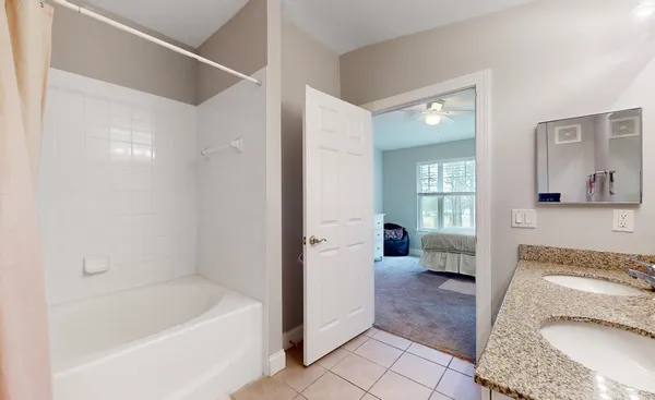 a bathroom with a tub a sink and a mirror