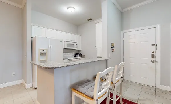 a kitchen with stainless steel appliances granite countertop a sink and a refrigerator