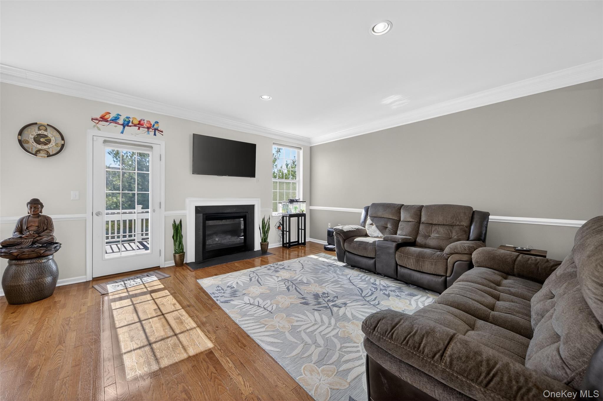 33 Pritchard Court Fishkill, NY 12524 - Photo 7 of 47 Living Room with gas fireplace, Oak hardwood flooring and doorway leading to trex deck.