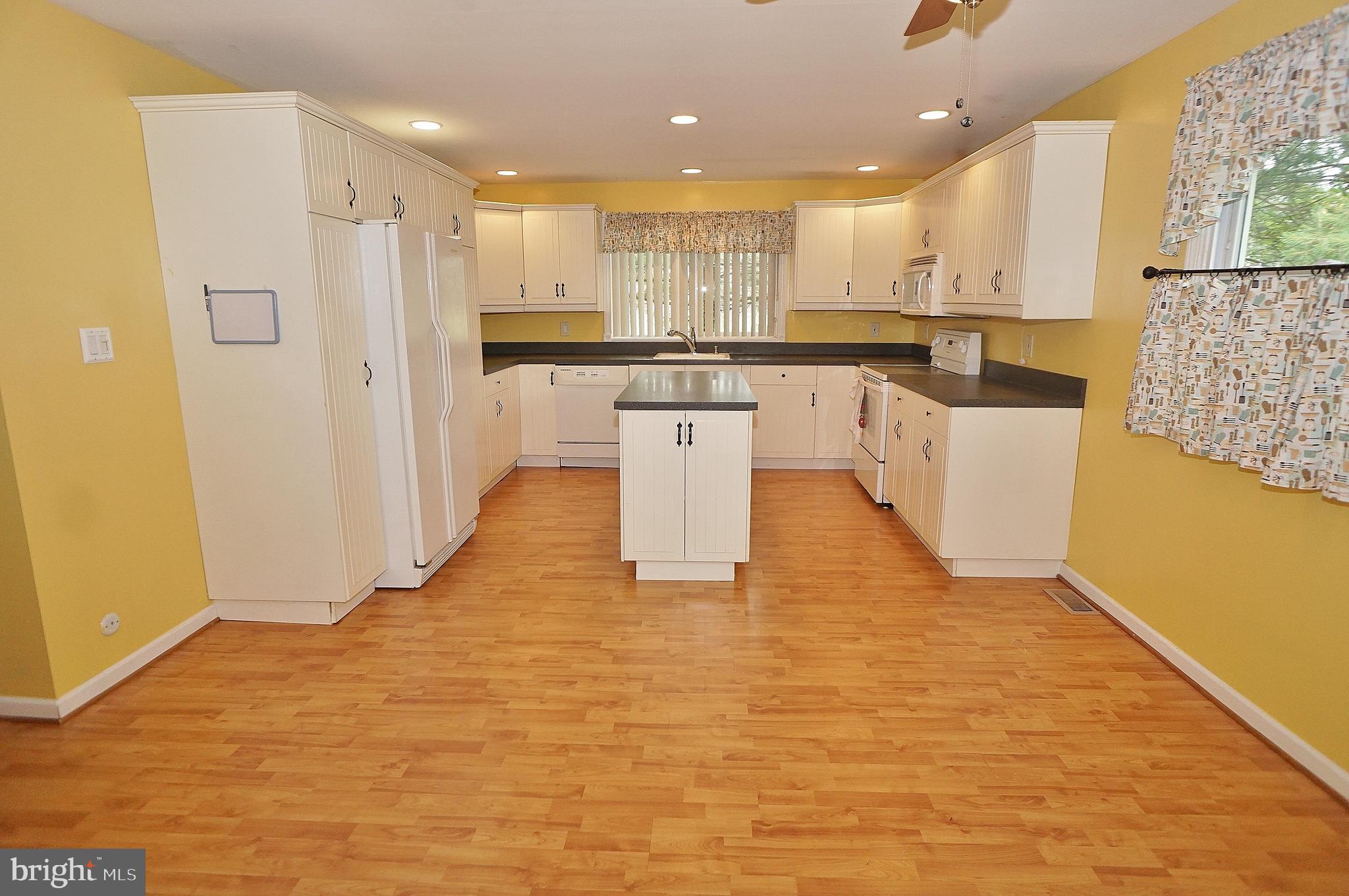 10 Upper Neck Road Pittsgrove, NJ 08318 - Photo 7 of 18 a large kitchen with stainless steel appliances kitchen island a stove a refrigerator a sink dishwasher and a oven with wooden floor