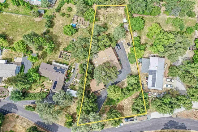 a balcony with wooden floor table and chairs