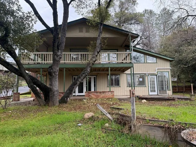 a white toilet sitting next to a white sink and vanity