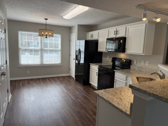 1026 Wolves Den Place Murfreesboro, TN 37128 - Photo 4 of 24 a kitchen with granite countertop wooden floors stainless steel appliances a sink and a window