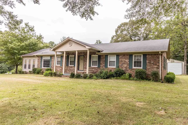 a front view of a house with a yard and porch