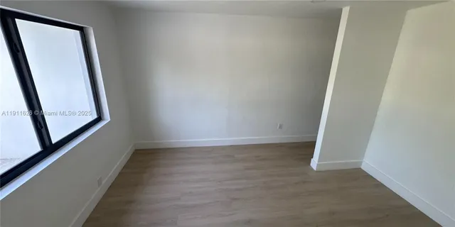 a bedroom with a bed a mirror and dresser