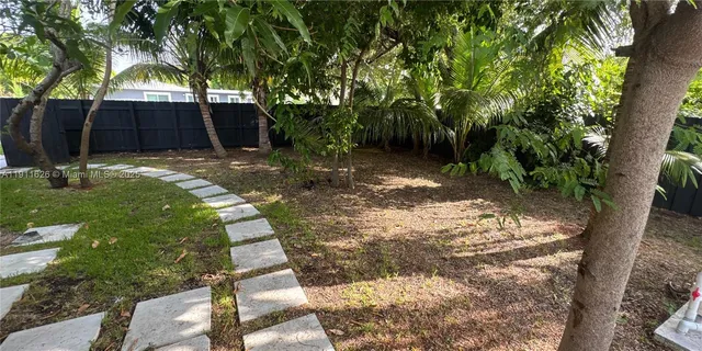 a view of a house with a tree in a yard