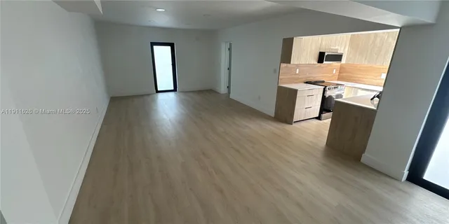 a kitchen with stainless steel appliances a refrigerator and a stove