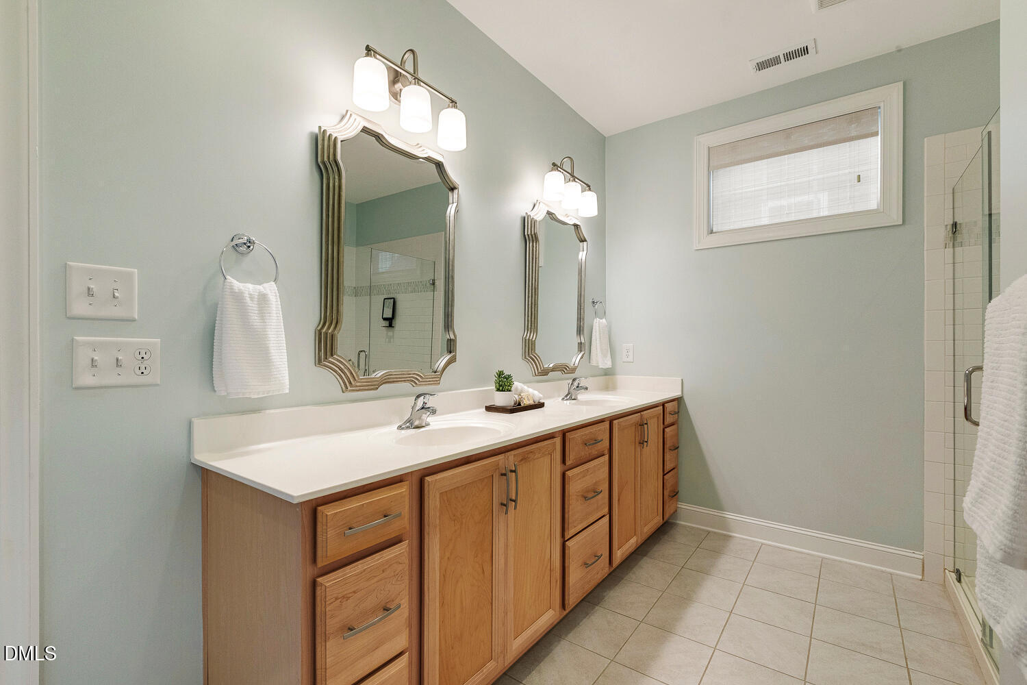 538 Rowanwood Way Apex, NC 27523 - Photo 20 of 40 a bathroom with a double vanity sink and a mirror