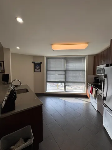 a view of a room with gym equipment and a large window