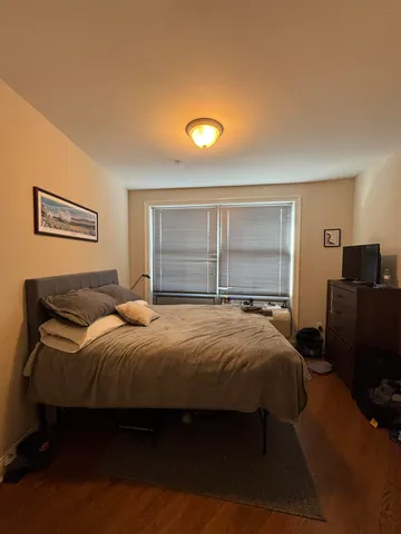 a bedroom with a bed and window