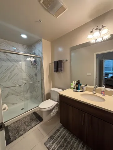 a bathroom with a sink toilet a mirror and a shower