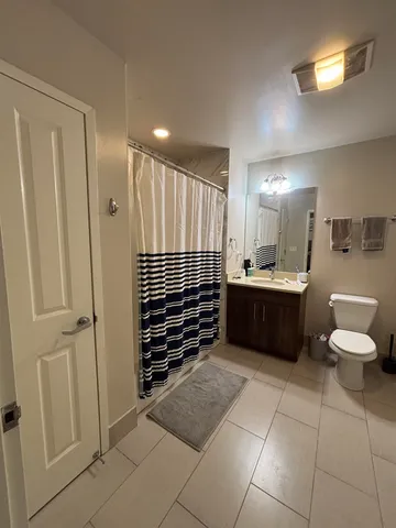 a bathroom with a sink a toilet and a mirror