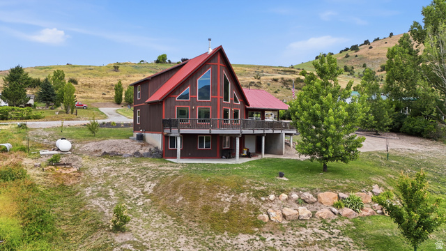 306 Spring Road Preston, ID 83263 - Photo 55 of 55 A-frame style residence featuring a prominent red metal roof, expansive upper-level balcony, and large picture windows