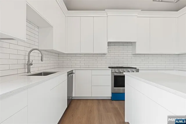 a kitchen with white cabinets and white appliances