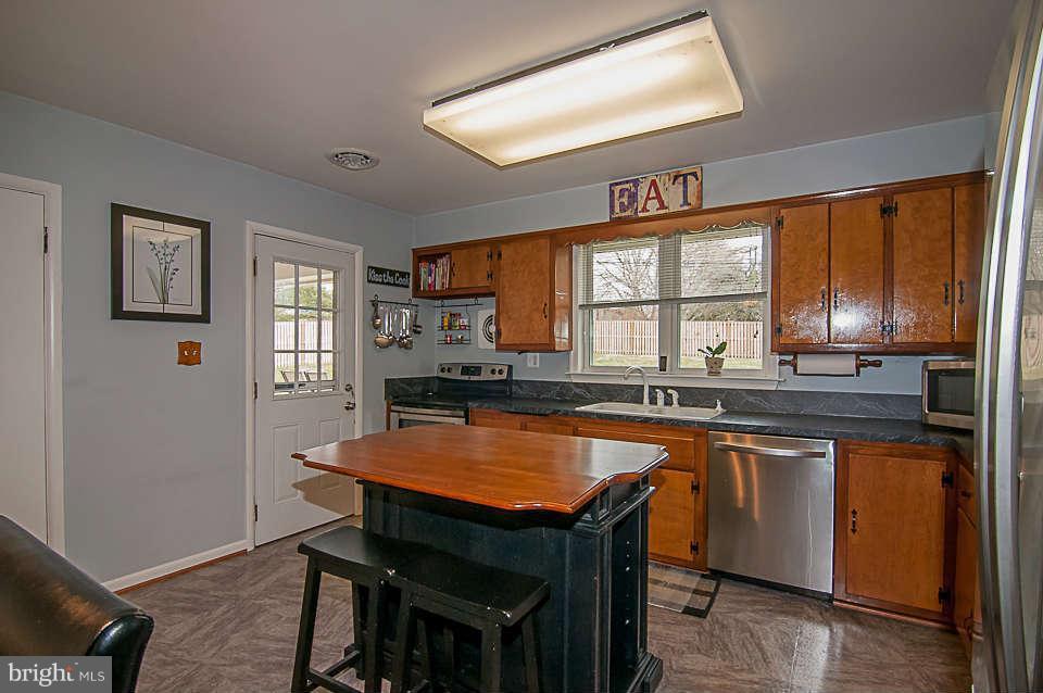 3721 Macalpine Road Ellicott City, MD 21042 - Photo 15 of 22 a kitchen with a table chairs sink and cabinets