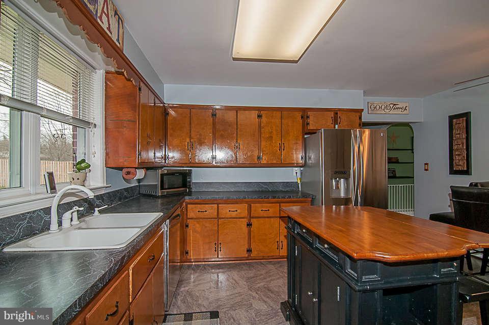 3721 Macalpine Road Ellicott City, MD 21042 - Photo 16 of 22 a kitchen with stainless steel appliances granite countertop a sink a stove and a refrigerator