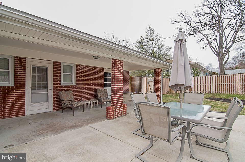 3721 Macalpine Road Ellicott City, MD 21042 - Photo 20 of 22 a view of a patio with a table and chairs and wooden fence