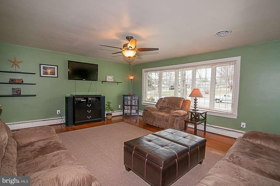 3721 Macalpine Road Ellicott City, MD 21042 - Photo 3 of 22 a living room with furniture a fireplace and a flat screen tv