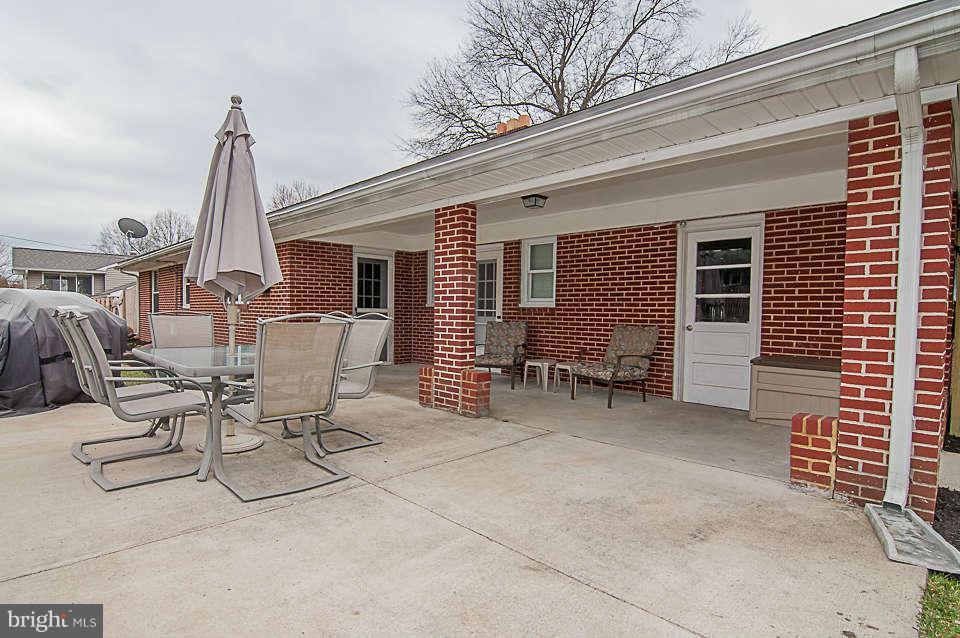 3721 Macalpine Road Ellicott City, MD 21042 - Photo 4 of 22 a view of a patio with a table and chairs and barbeque grill