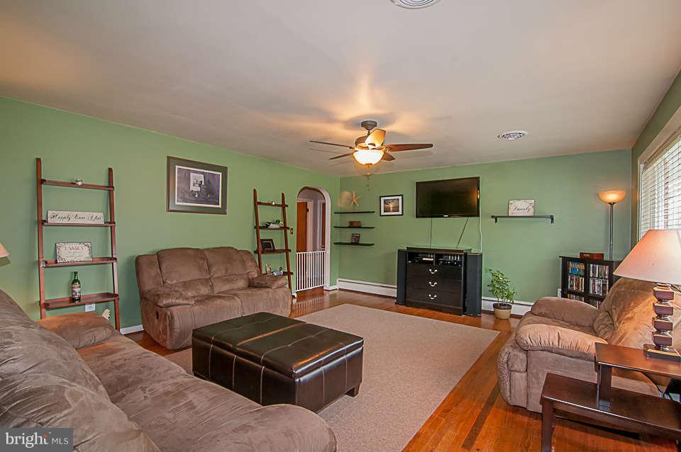 3721 Macalpine Road Ellicott City, MD 21042 - Photo 5 of 22 a living room with furniture and a fireplace