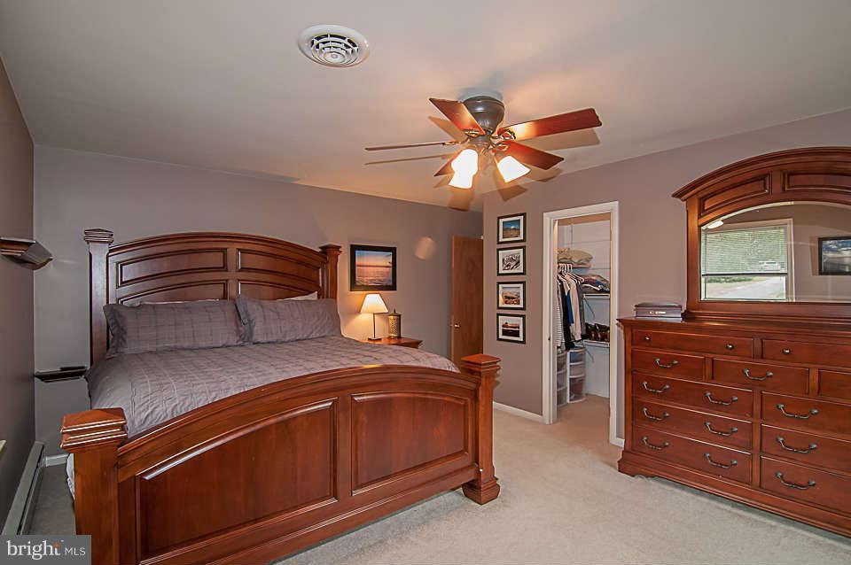 3721 Macalpine Road Ellicott City, MD 21042 - Photo 9 of 22 a bedroom with a bed and a chandelier