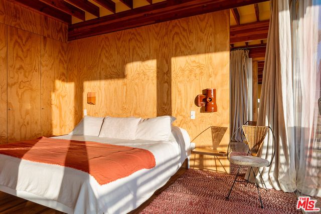 a view of a room with wooden floor and door