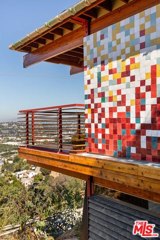 a dining room with furniture and large windows