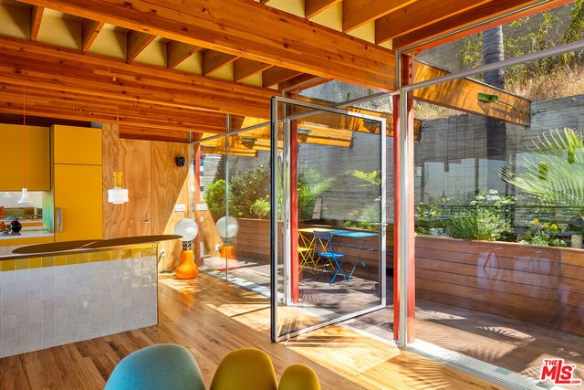 a view of living room with patio furniture and potted plants