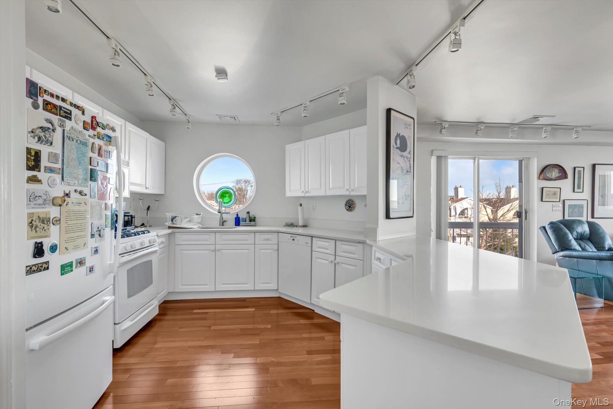 190 Schofield Street Bronx, NY 10464 - Photo 5 of 17 a large white kitchen with lots of counter space and wooden floor