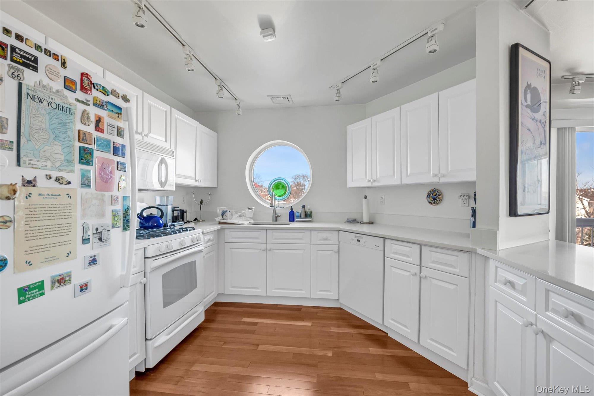 190 Schofield Street Bronx, NY 10464 - Photo 6 of 17 a large white kitchen with stainless steel appliances granite countertop lots of counter top space and wooden floor