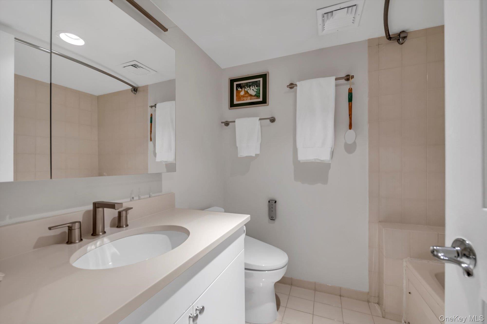 190 Schofield Street Bronx, NY 10464 - Photo 9 of 17 a bathroom with a granite countertop sink toilet and shower