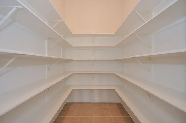 a view of a room with shelves on the wall