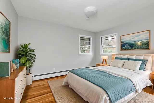 a bedroom with bed and a potted plant