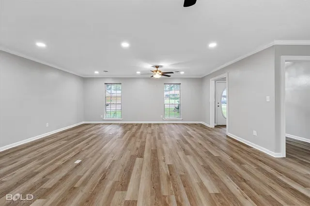 a view of an empty room with window and cabinet