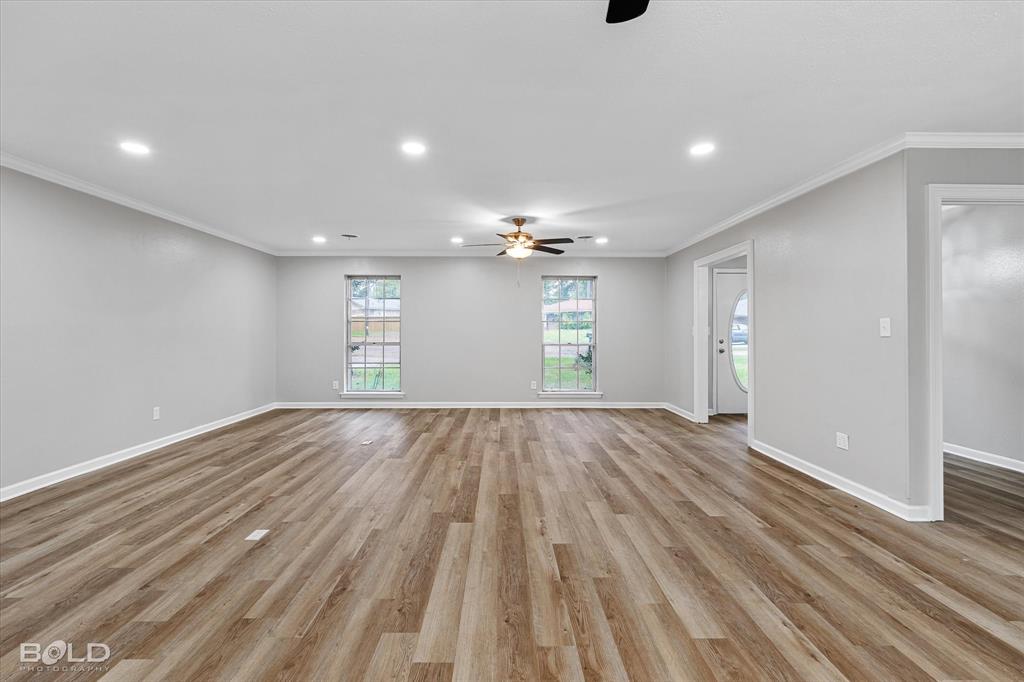 9471 Hemlock Circle Shreveport, LA 71118 - Photo 10 of 36 a view of an empty room and window and wooden floor