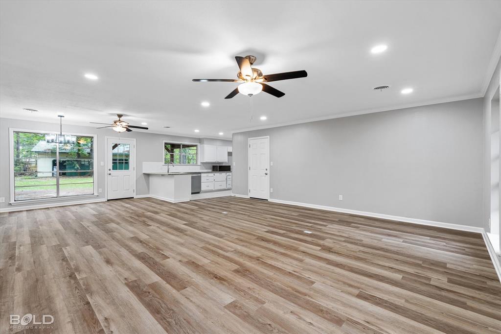 9471 Hemlock Circle Shreveport, LA 71118 - Photo 12 of 36 wooden floor in an empty room with a kitchen