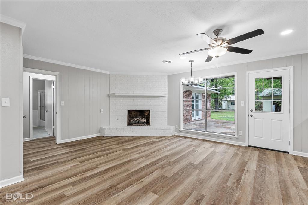 9471 Hemlock Circle Shreveport, LA 71118 - Photo 13 of 36 a view of an empty room with wooden floor fireplace and a window