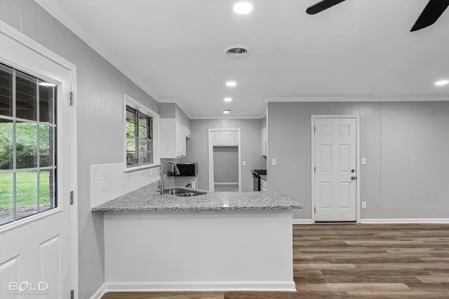 a kitchen with stainless steel appliances granite countertop a stove and a refrigerator