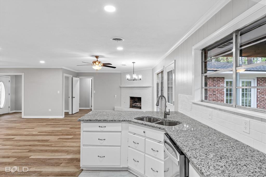 9471 Hemlock Circle Shreveport, LA 71118 - Photo 16 of 36 a bathroom with a granite countertop sink and a large mirror