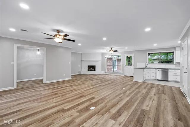 a view of a livingroom with a furniture wooden floor and chandelier