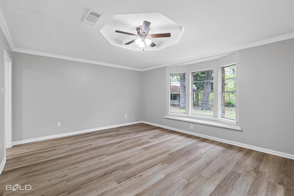 9471 Hemlock Circle Shreveport, LA 71118 - Photo 21 of 36 a view of an empty room with wooden floor and a window