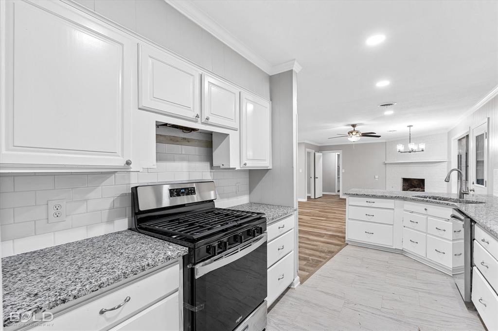 9471 Hemlock Circle Shreveport, LA 71118 - Photo 36 of 36 a kitchen with granite countertop a stove sink and cabinets