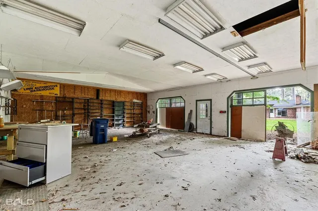 a view of a big room with air conditioner duct and materials on floor