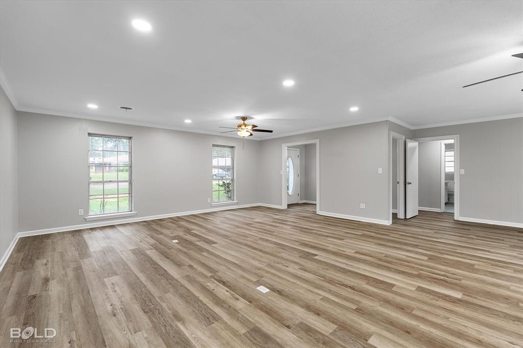 9471 Hemlock Circle Shreveport, LA 71118 - Photo 8 of 36 a view of an empty room with wooden floor and a window